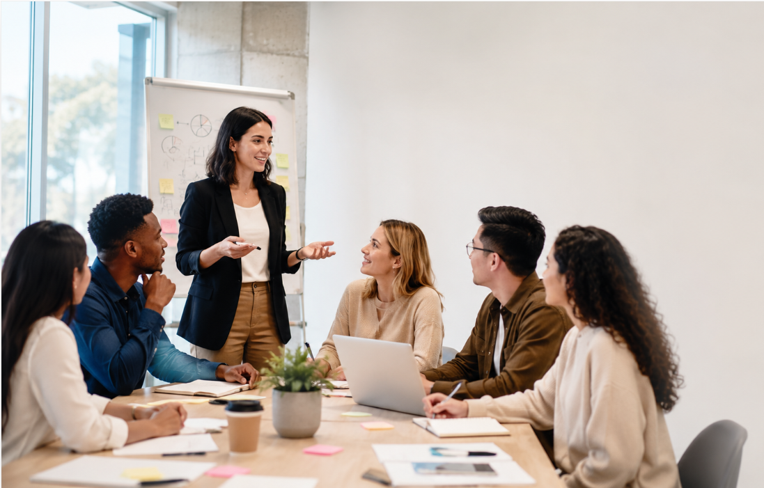 A leader facilitating a diverse team meeting in an office